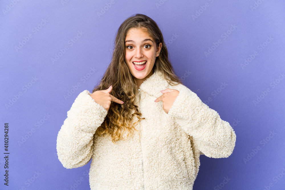 Young caucasian cute woman surprised pointing with finger, smiling broadly. Young caucasian cute woman surprised pointing with finger, smiling broadly.