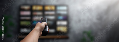 Foto concept - man with his remote control watching tv in his living room