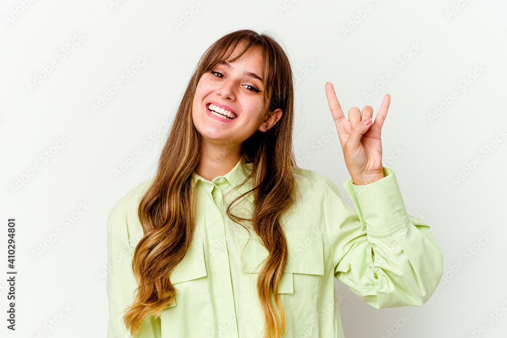 Young caucasian cute woman isolated on white background showing a horns gesture as a revolution concept. Young caucasian cute woman isolated on white background showing a horns gesture as a revolution concept.