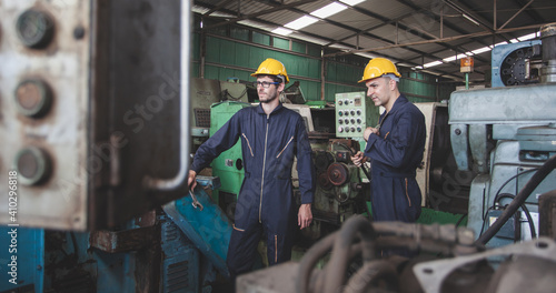 Two workers at an industrial plant. working together manufacturing activities.. worker and engineer under inspection and checking production process on factory