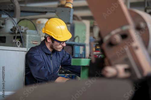 industrial worker is working at a heavy industry manufacturing plant. worker in factory on the machine