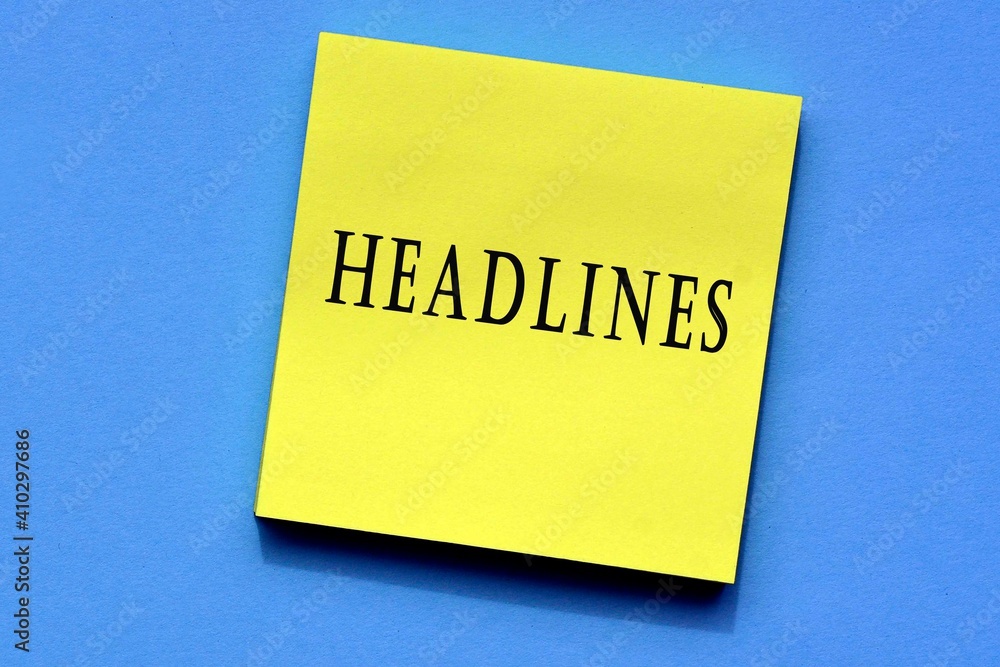 Headlines on yellow sticky note. News concept Headlines on yellow sticky note. News concept