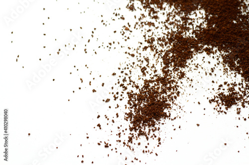 Ground coffee beans against white background