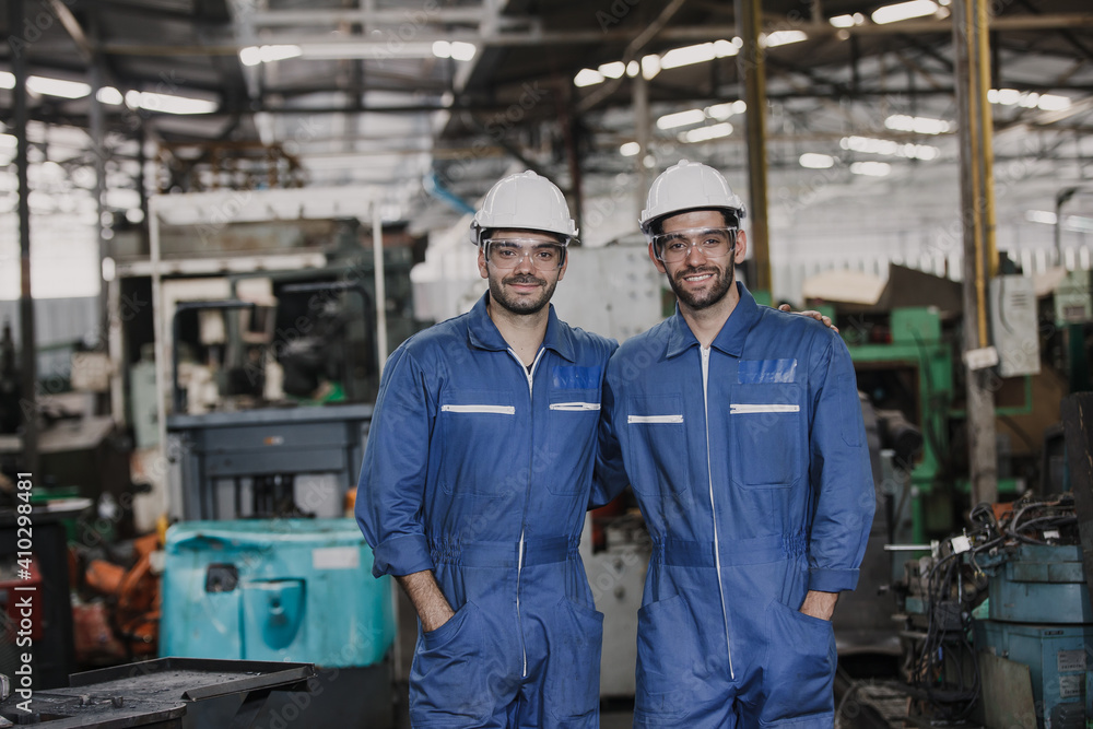 Portrait of an engineer at work in a factory. worker in factory on the machine Portrait of an engineer at work in a factory. worker in factory on the machine