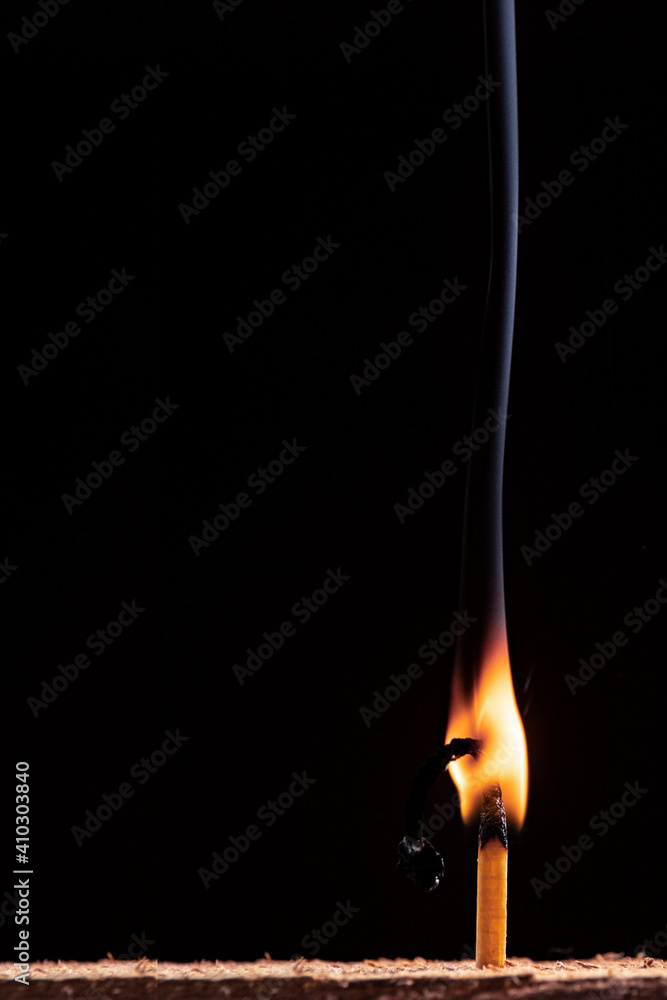 burning match on black background burning match on black background