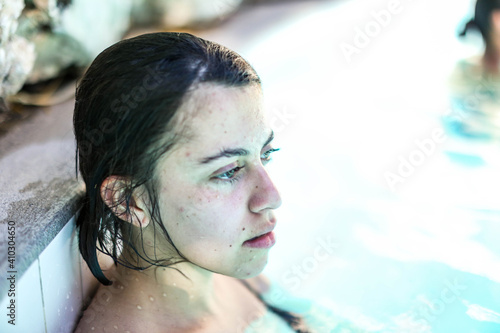 Young woman swim in the swimming pool photo