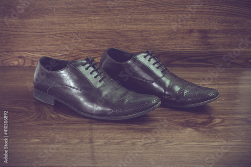 men's formal elegant black shoes on wooden planks