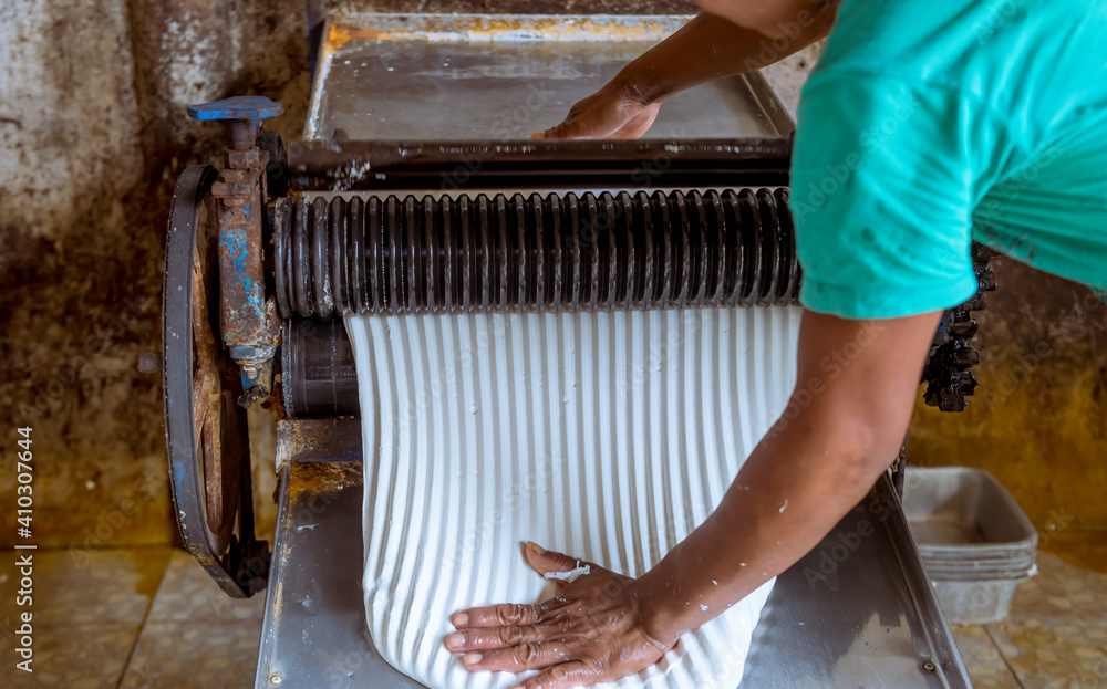 The farmer making rubber sheets hang on bamboo process dry by solar