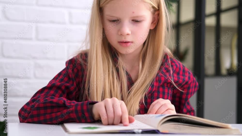 4k Blonde schoolgirl studying at home doing school homework. Training books and notebooks on table. Distance learning online education 4k Blonde schoolgirl studying at home doing school homework. Training books and notebooks on table. Distance learning online education