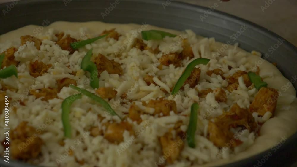 Green Peppers Being Placed On Fresh Pizza. Slow Motion, Close Up Green Peppers Being Placed On Fresh Pizza. Slow Motion, Close Up