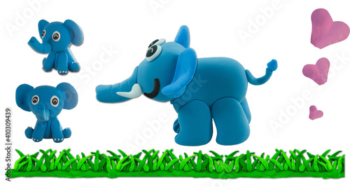 Set of plasticine elephant and son on green grass in concept wild nature and family