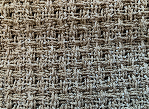Brown background. The texture of a coarse fabric woven from a thick thread. Close-up