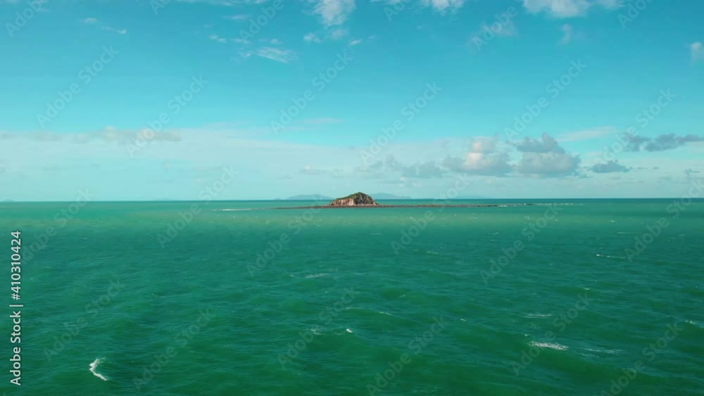 Aerial view towards the Slade Island Reef, sunny day, in Great Barrier Reef Marine Park, Coral Sea, Australia - Approaching, drone shot Aerial view towards the Slade Island Reef, sunny day, in Great Barrier Reef Marine Park, Coral Sea, Australia - Approaching, drone shot