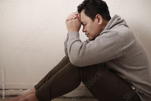 Sad depressed anxiety Asian man thinking contemplating bad thing happened in his life, stress exhausted feeling down expression, financial or relationship problem
