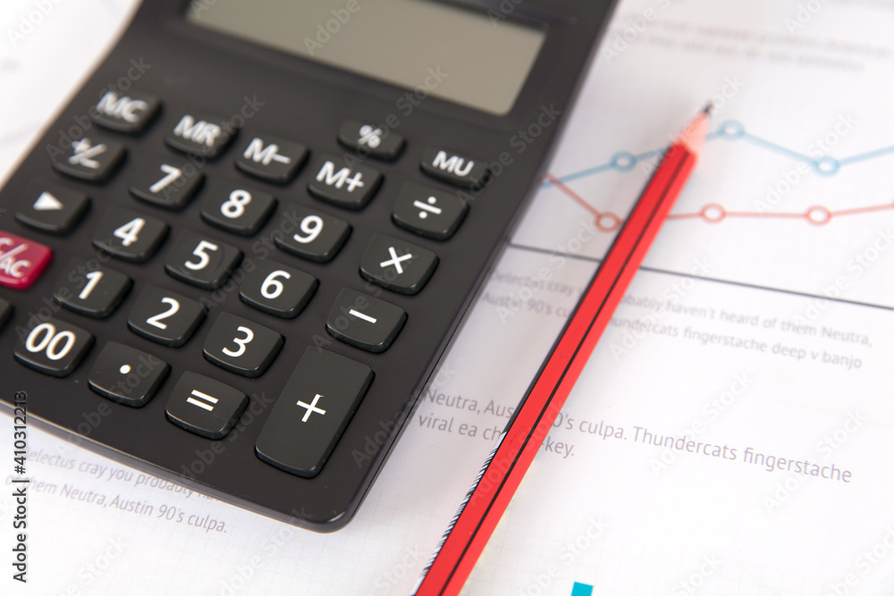 Calculators and pencils on financial charts Calculators and pencils on financial charts
