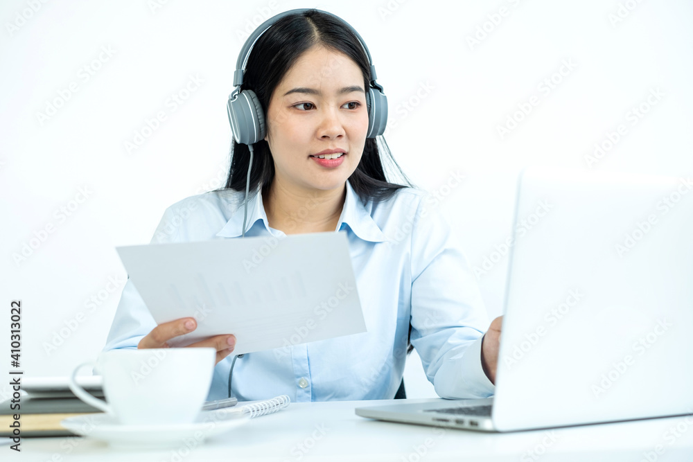 Asian female accountant sits at their desks and calculates financial graphs showing results about their investments, plan a successful business growth process Asian female accountant sits at their desks and calculates financial graphs showing results about their investments, plan a successful business growth process