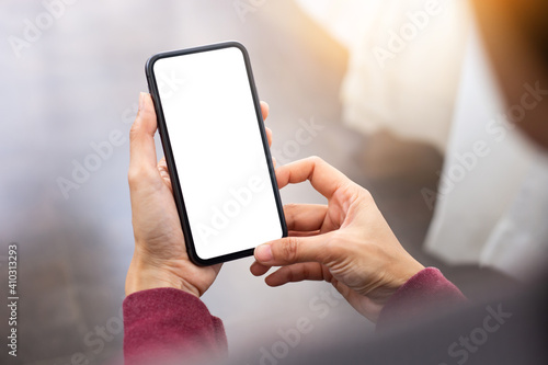 cell phone blank white screen mockup.woman hand holding texting using mobile on desk at office.background empty space for advertise.work people contact marketing business,technology © panitan