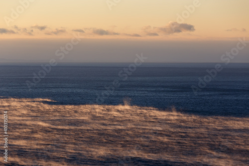 Water of Baikal lake in December with fog over water