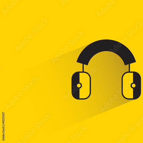 protective ear muffs with shadow on yellow background