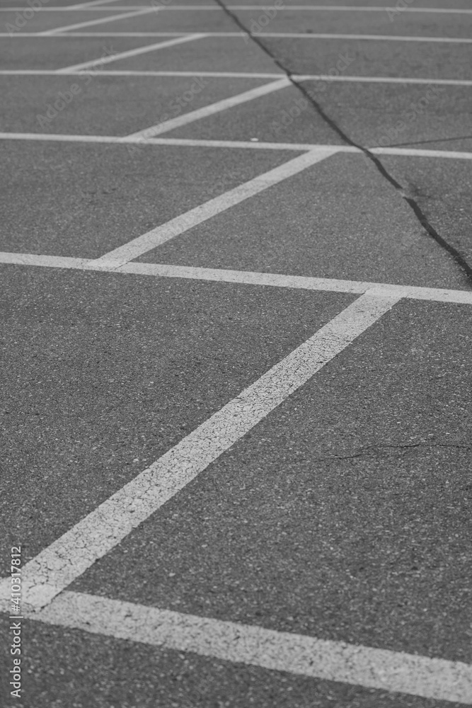 Parking lot lines on asphalt.