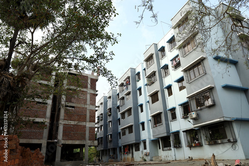 A ground level view of a completed apartment and a under construction apartment