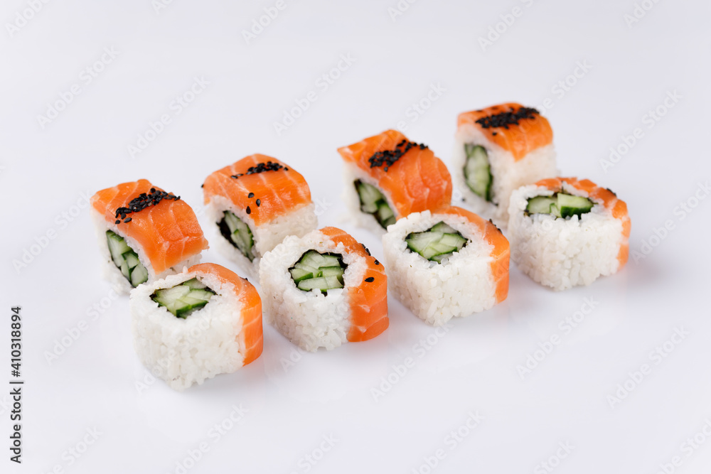 Philadelphia roll with cucumberon white background. Isolated. Sushi menu. Japanese food. Philadelphia roll with cucumberon white background. Isolated. Sushi menu. Japanese food.