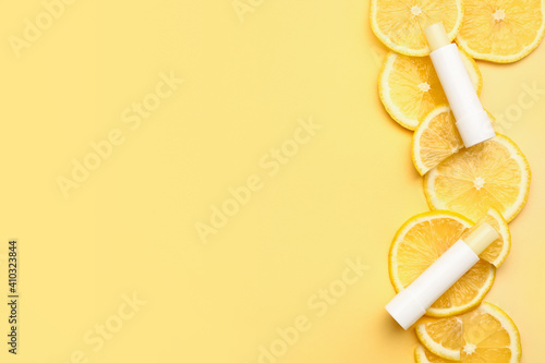 Natural lip balms with lemon on color background