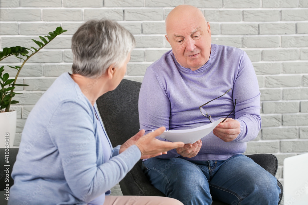 Stressed senior couple in debt at home Stressed senior couple in debt at home