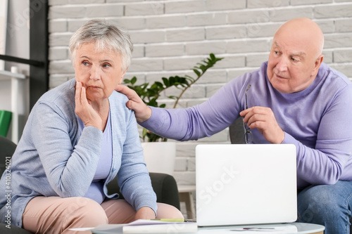 Stressed senior couple with...