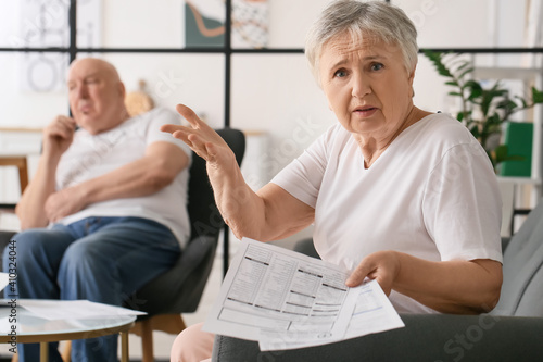 Stressed senior couple in d...