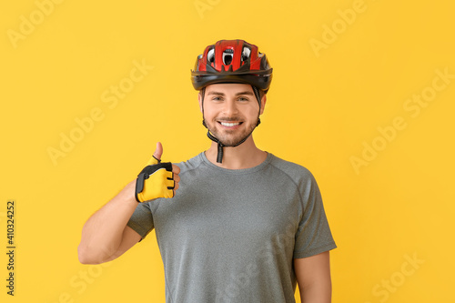 Male cyclist showing thumb-...