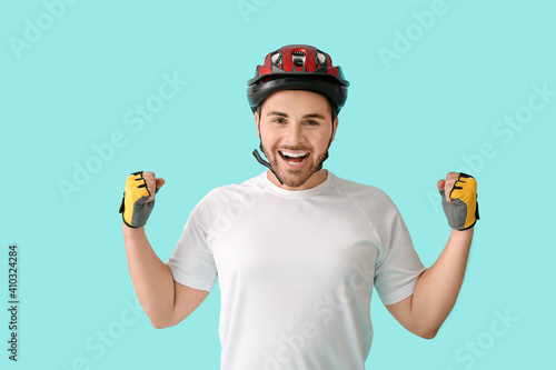Happy male cyclist on color...