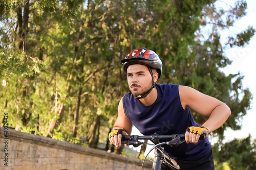 Fototapeta Naklejka Na Ścianę i Meble -  Male cyclist riding bicycle outdoors