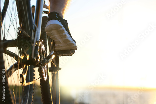 Fototapeta Male cyclist riding bicycle outdoors, closeup