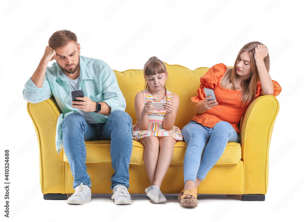 Sad family with mobile phones on sofa against white background Sad family with mobile phones on sofa against white background
