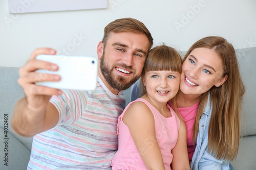 Happy family taking selfie ...