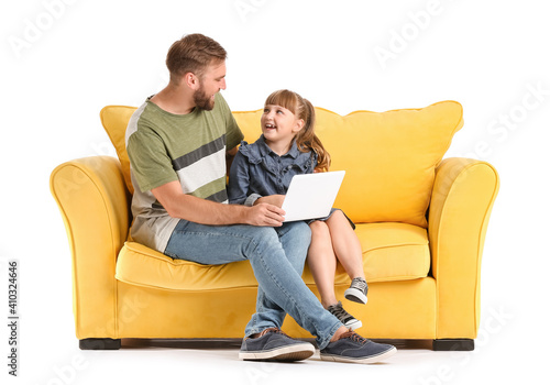 Father and daughter with laptop on sofa against white background