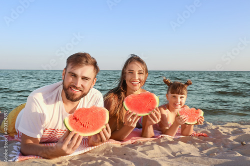 Happy family eating waterme...