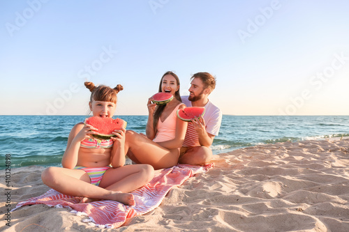 Happy family eating waterme...