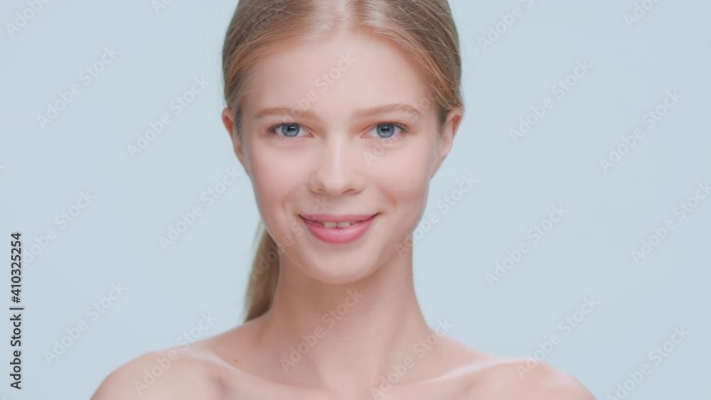 Young attractive blonde beauty model slowly turns to the camera and smiles | Skin care commercial concept Young attractive blonde beauty model slowly turns to the camera and smiles | Skin care commercial concept