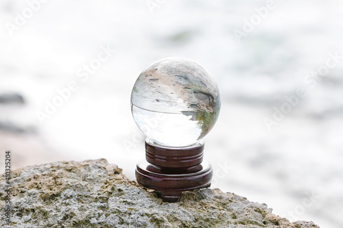 Crystal ball of fortune teller outdoors near river photo