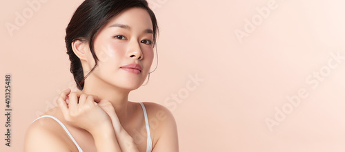 Obraz na plátně Beautiful young asian woman with clean fresh skin on beige background, Face care