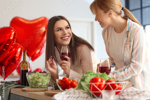 Happy transgender couple celebrating Valentine s Day while cooking festive dinner at home