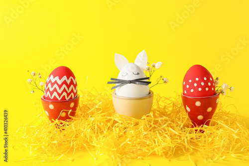 Creative composition with Easter eggs on color background