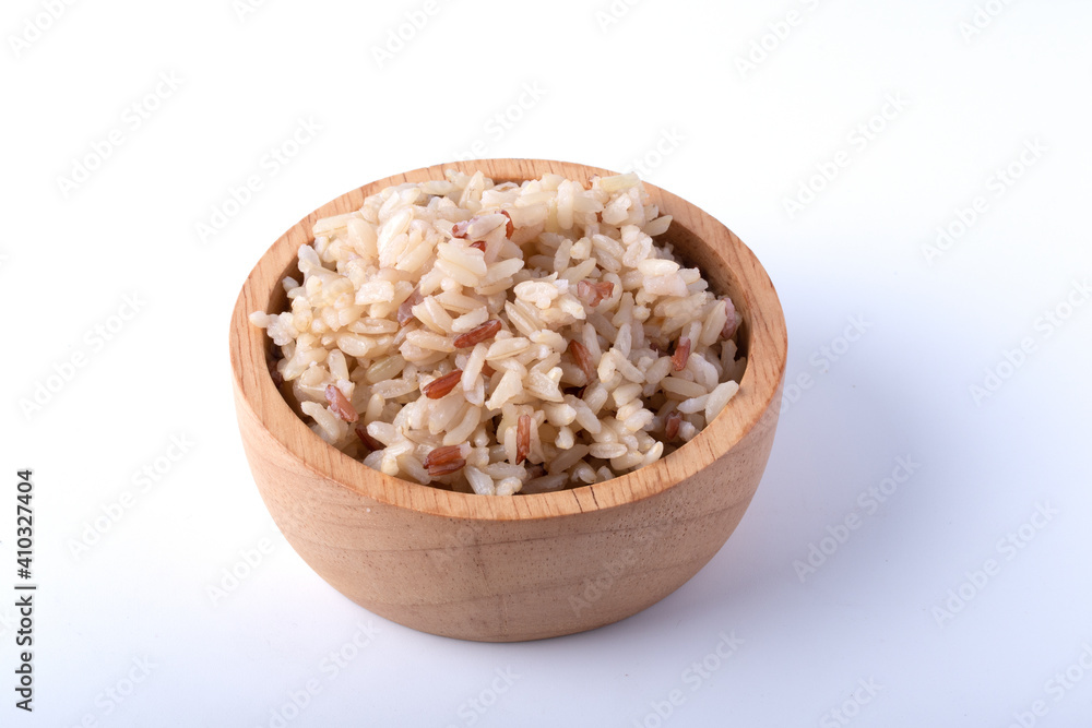 Jasmine brown rice in wooden cup on white background Jasmine brown rice in wooden cup on white background