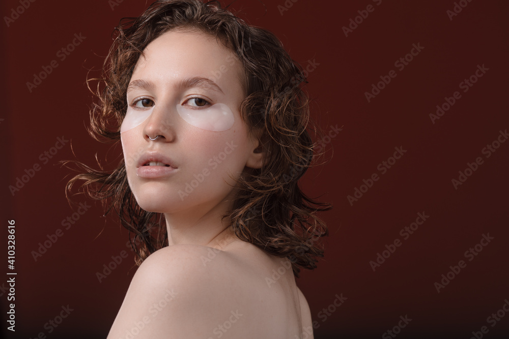 Eye Skin Beauty. Portrait Of Beautiful Young Female Model With Natural Facial Makeup And Under Eye Care Product On Face On White Background. High Resolution Eye Skin Beauty. Portrait Of Beautiful Young Female Model With Natural Facial Makeup And Under Eye Care Product On Face On White Background. High Resolution
