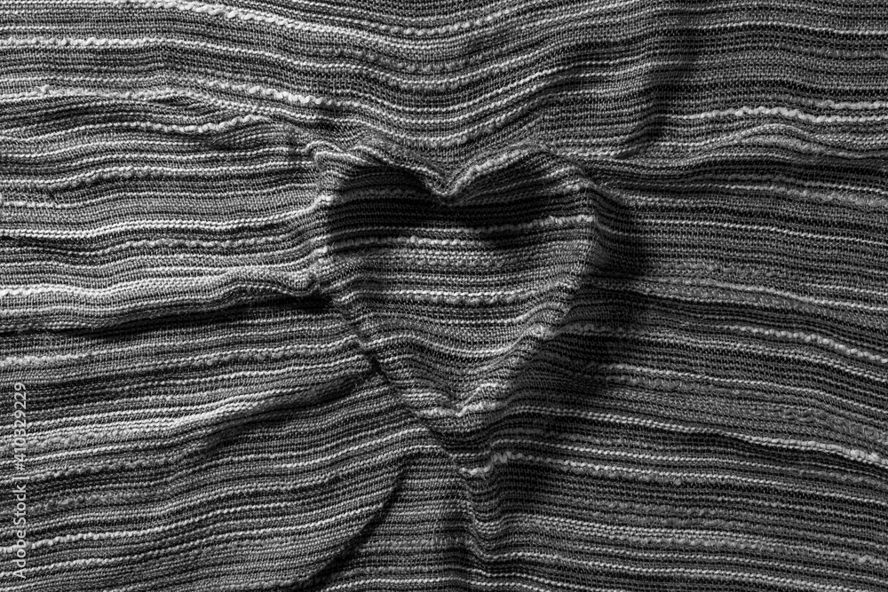 Heart from textile background for valentines Day and Love thematic wallpaper. Black and White photo.