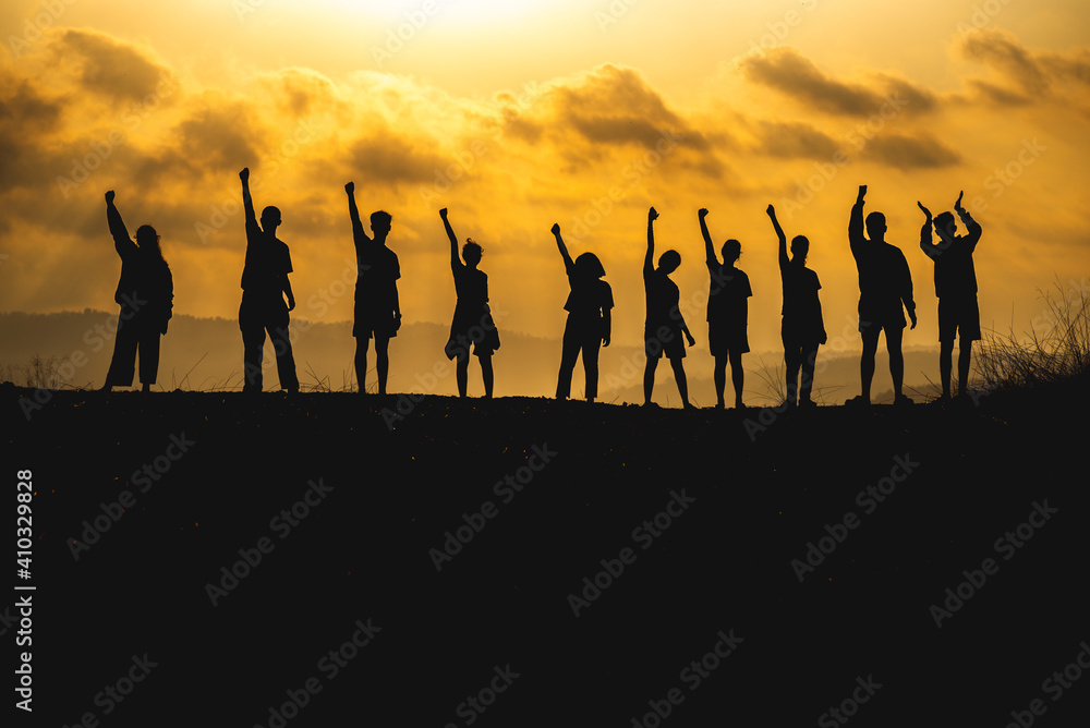 The silhouette of a business network group of business people shaking hands to express the joy and celebration of the success of the marketing and business operations between companies