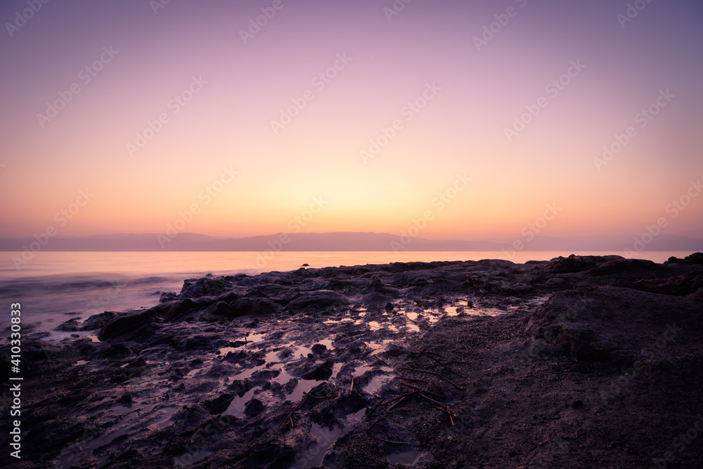 Long exposure of a wild beach in the Dead Sea, amazing colors of sunrise
