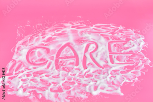 Washing concept. Soap foam on delicate pink background with copy space